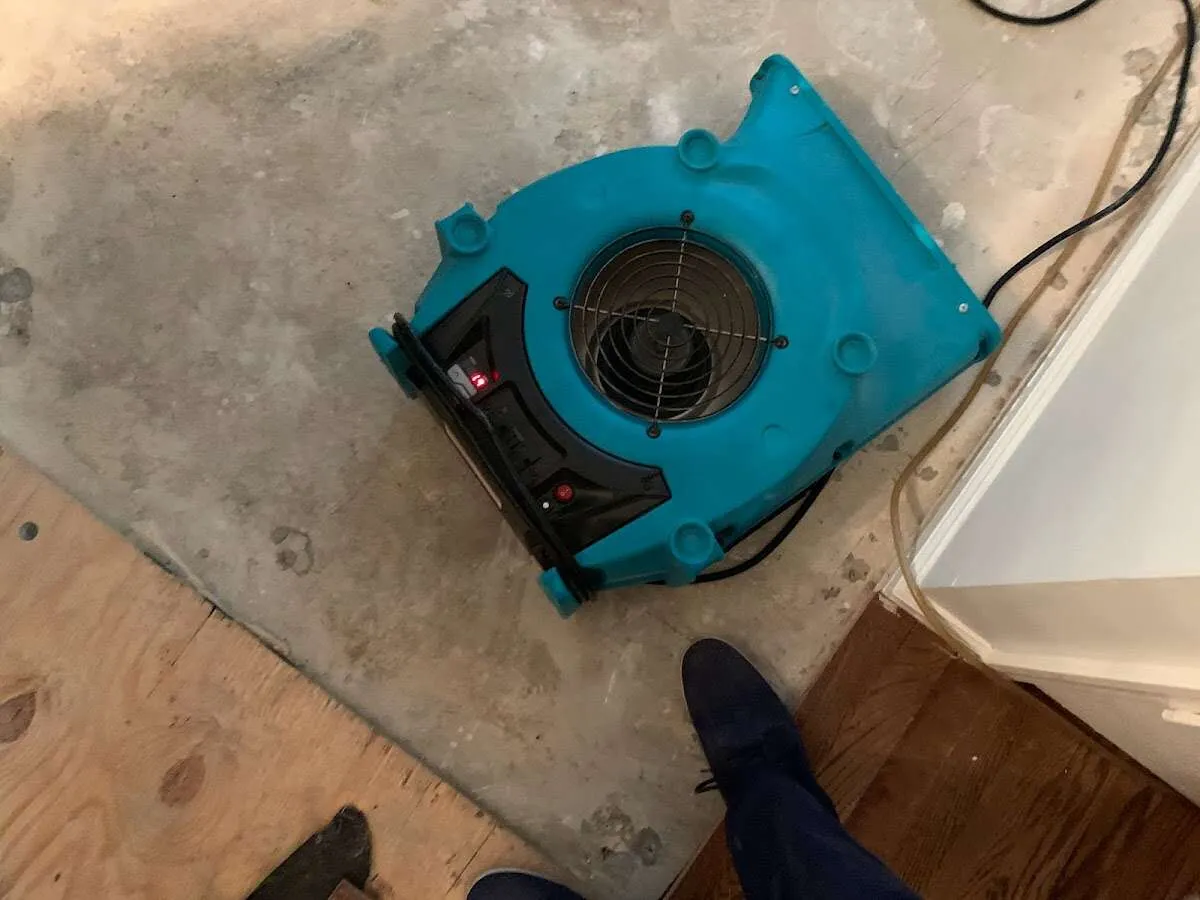 Air mover drying subfloor during Commercial Water Damage Restoration in Alamogordo